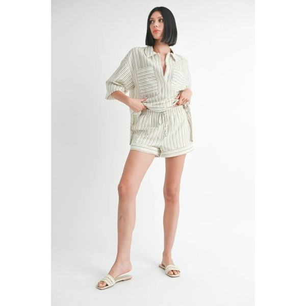 Woman wearing Emory Park women's linen shorts with a matching striped button-up shirt and slide sandals