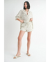 Woman wearing Emory Park women's linen shorts with a matching striped button-up shirt and slide sandals