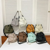 Collection of colorful women's nylon bucket bag styles by Trendsi displayed on table and hanging
