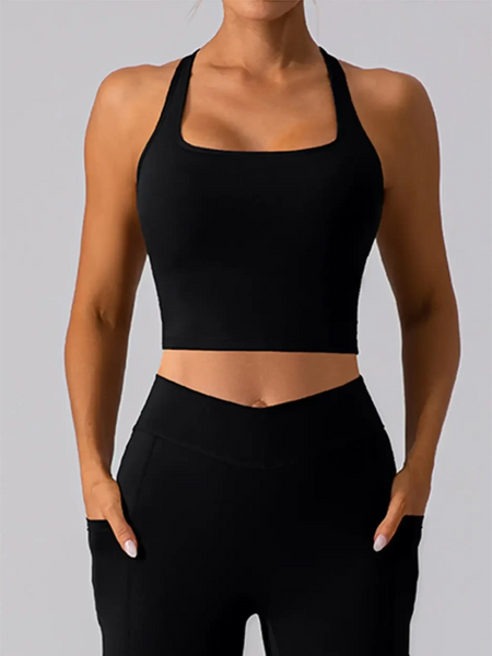Babe Beachwear women's racerback crop top active tank in black worn with black high-waisted pants