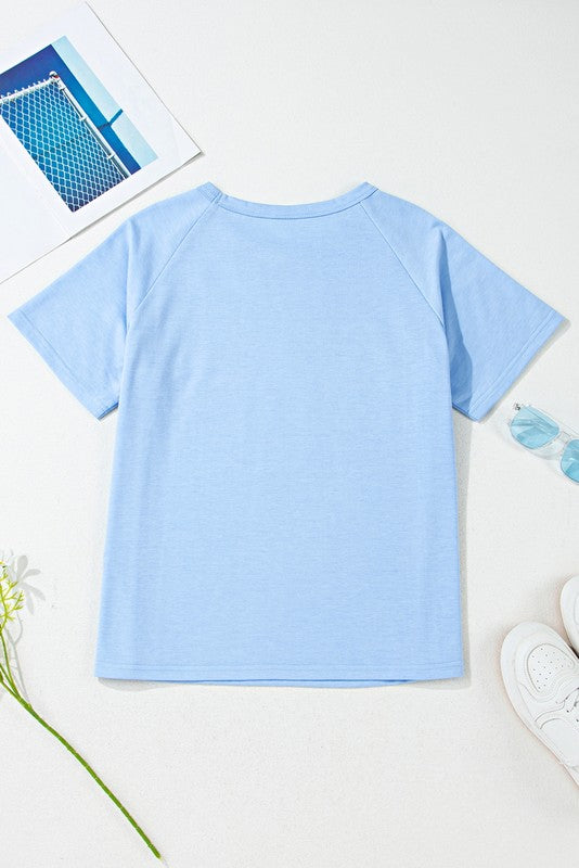 EG fashion women's raglan short sleeve top in light blue laid flat with accessories