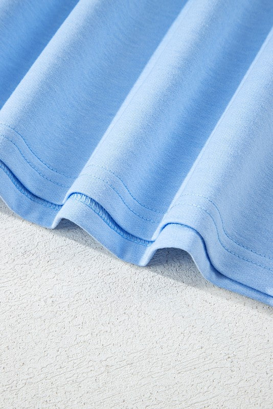 Close-up of light blue fabric hem of women's raglan short sleeve top by EG fashion