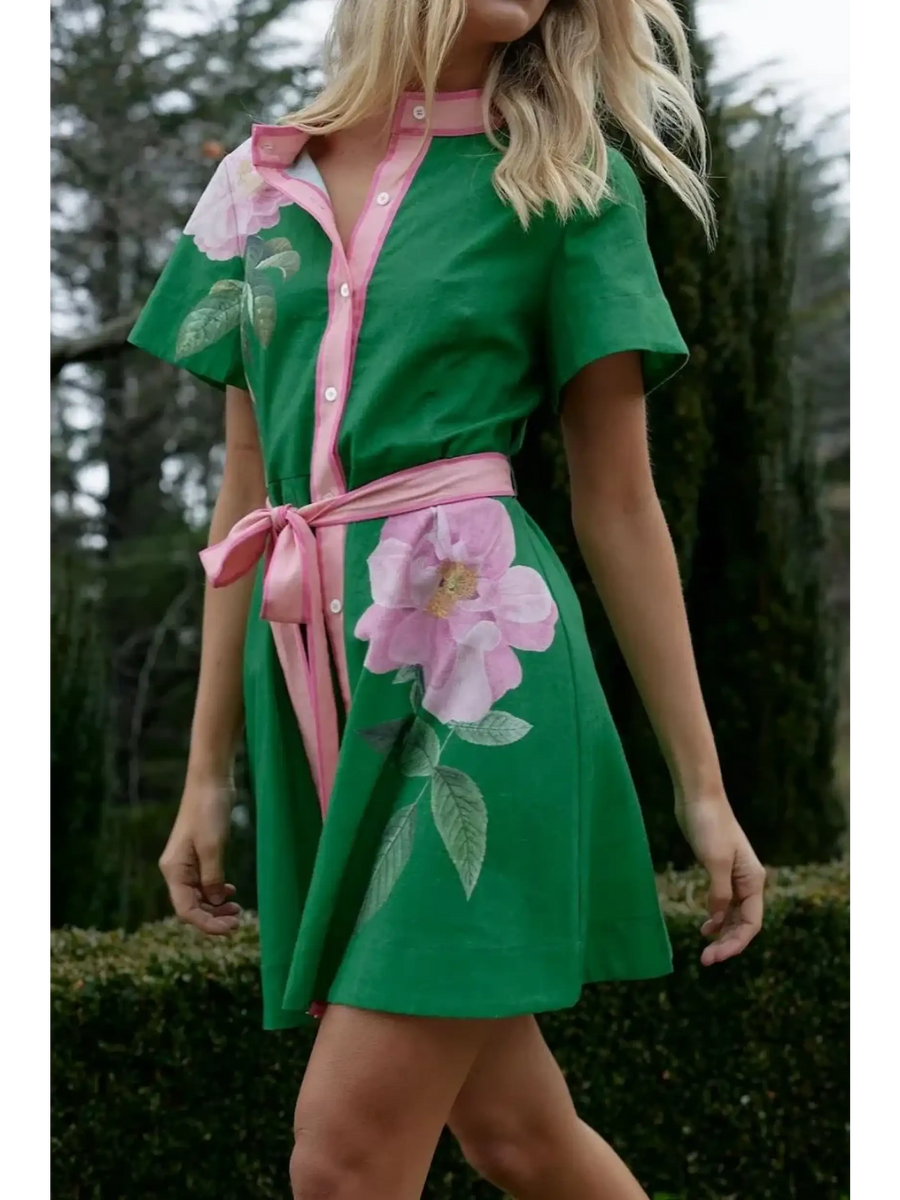 green women's resort wear short sleeve dress in green with pink floral accents and waist tie
