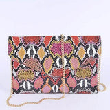 Babe Beachwear women's snake print handbag with bold multicolor pattern and gold chain strap