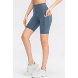 Babe Beachwear women's sports shorts with pockets in blue, featuring a high waist and side phone pocket