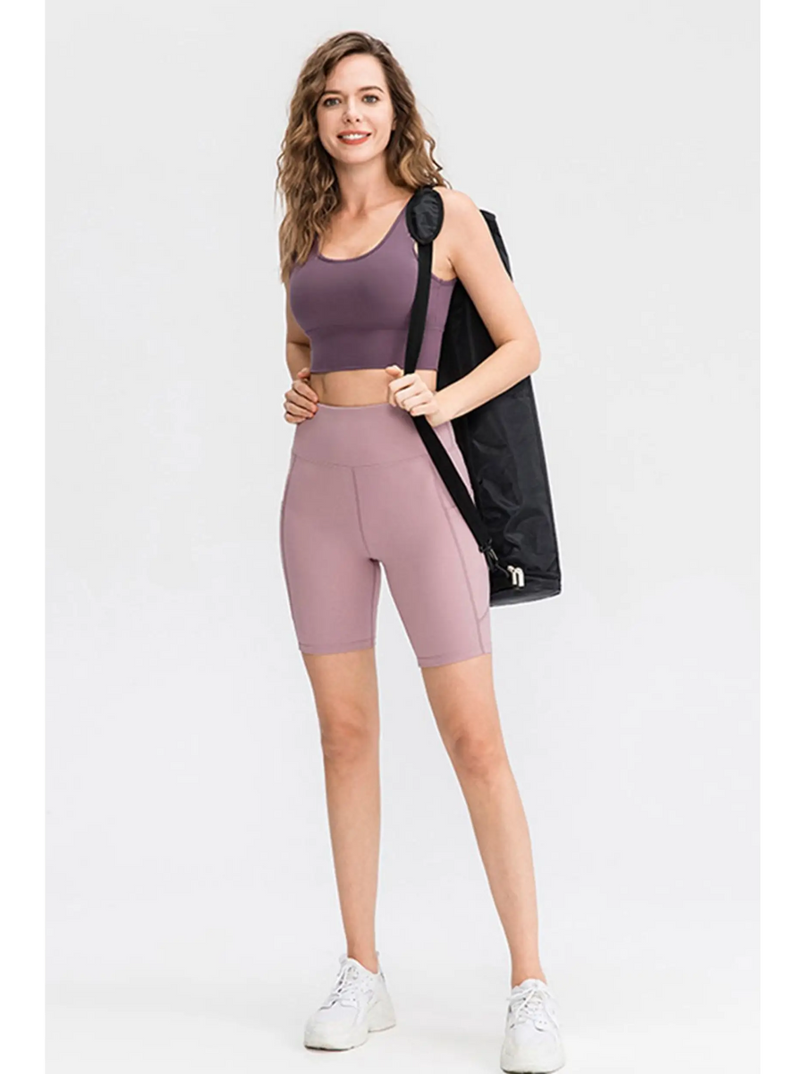 Woman wearing Babe Beachwear women's sports shorts with pockets in mauve and matching sports bra