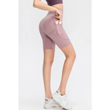 Women's sports shorts with pockets in mauve by Babe Beachwear shown with phone in side pocket