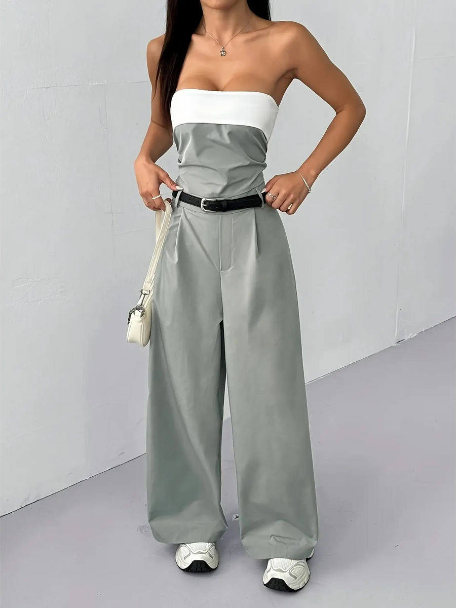 Trendsi women's strapless vacation jumpsuit with white top and gray wide-leg pants styled with belt and sneakers