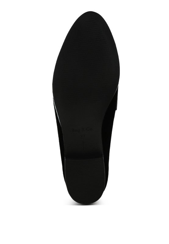 Sole view of women's studded suede loafers by Rag Company showing black textured outsole
