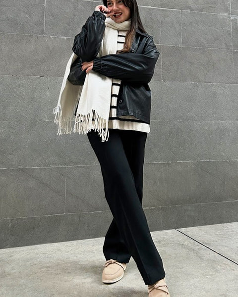 Rag Company women's suede loafers in beige worn with black pants and black jacket against gray wall