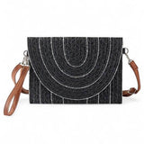 Babe Beachwear Small Clutch Shoulder bag in black with circular pattern and brown adjustable strap