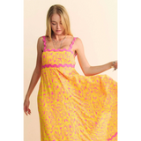 Trendsi yellow floral sundress for travel with pink trim and flowing maxi dress design