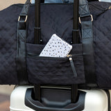 Black Babe Beachwear Zahra carry on overnight bag with quilted design on white suitcase handle