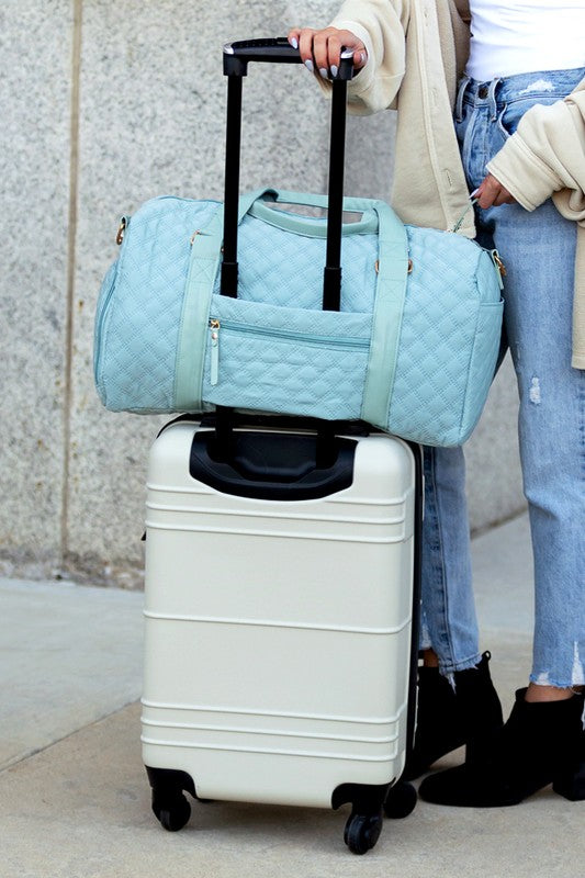 Babe Beachwear Zahra carry on overnight bag in light blue quilted design on white suitcase