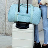 Babe Beachwear Zahra carry on overnight bag in light blue quilted design on white suitcase