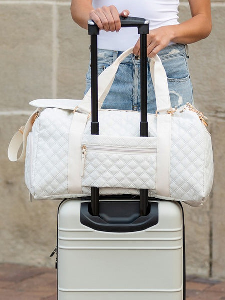 Babe Beachwear white quilted Zahra carry on overnight bag attached to silver hard suitcase