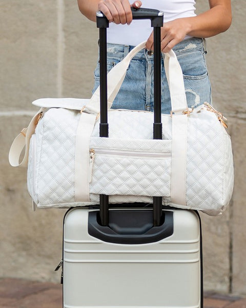 Babe Beachwear white quilted Zahra carry on overnight bag attached to silver hard suitcase