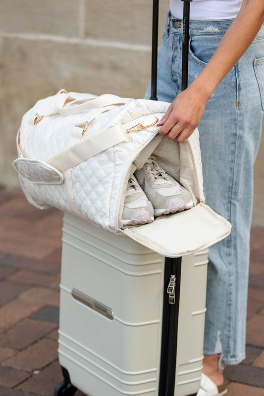 Babe Beachwear Zahra carry on overnight bag in white quilted design holding shoes on luggage