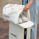 Babe Beachwear Zahra carry on overnight bag in white quilted design holding shoes on luggage