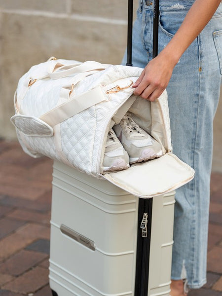 Babe Beachwear Zahra carry on overnight bag in white quilted design holding shoes on luggage